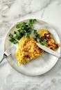 Appetizing omelette served with fresh parsley on a marble table. Perfect breakfast or brunch meal.