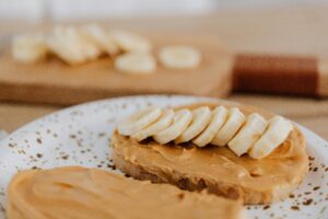 Slice of toast with peanut butter and banana slices, perfect for a healthy snack.